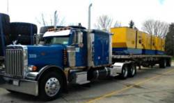 Photo of a BTI tractor loaded with a full flatbed.