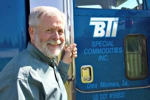 Photo of retired safety director Gary Handley in front of BTI truck.