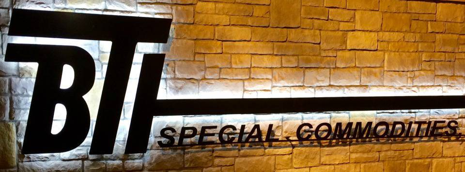Photo of a BTI Special Commodities sign at night.