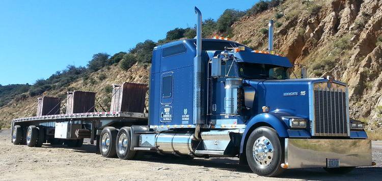 Photo of a parked BTI Tractor with a small load.