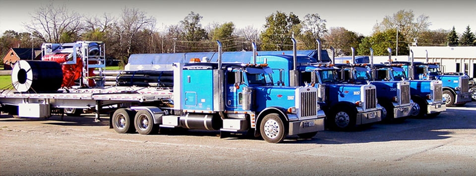 Photo of multiple BTI trucks lined up before departing.