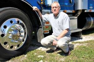 Photo of truck broker John Dickson next to a BTI truck.